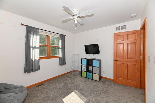 2855 N Shore Dr, Delavan, WI 53115 - rec room with baseboards, visible vents, carpet, and a ceiling fan