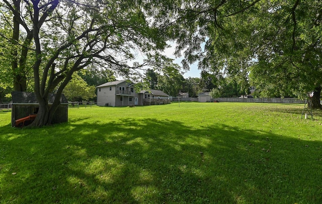 2855 N Shore Dr, Delavan, WI 53115 - view of yard featuring a storage unit, an outbuilding, and fence