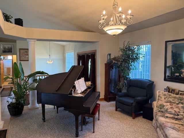 2026 Stonehaven Dr, Sun Prairie, WI 53590 - living area featuring a chandelier, ornate columns, light carpet, and a wealth of natural light