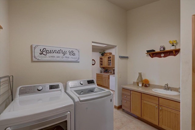 2026 Stonehaven Dr, Sun Prairie, WI 53590 - laundry room featuring cabinet space, separate washer and dryer, light tile patterned flooring, and a sink
