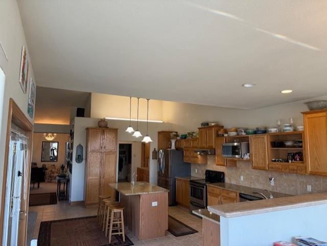 2026 Stonehaven Dr, Sun Prairie, WI 53590 - kitchen with appliances with stainless steel finishes, light countertops, backsplash, a kitchen bar, and light tile patterned flooring