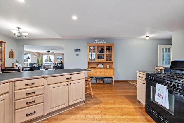 W1335 N Blue Spring Lake Dr, Palmyra, WI 53156 - kitchen featuring recessed lighting, black gas range, ceiling fan with notable chandelier, baseboards, and light wood finished floors