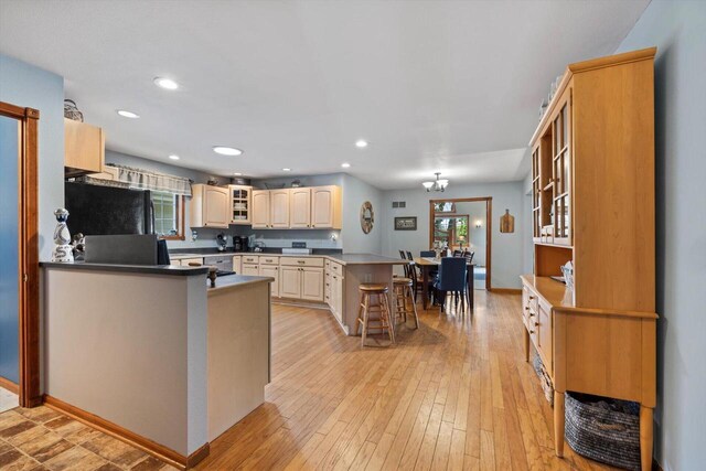 W1335 N Blue Spring Lake Dr, Palmyra, WI 53156 - kitchen featuring glass insert cabinets, a healthy amount of sunlight, a peninsula, and light wood finished floors