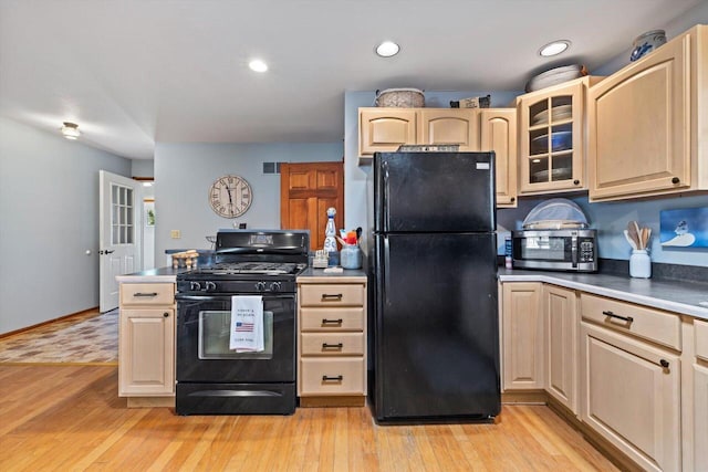 W1335 N Blue Spring Lake Dr, Palmyra, WI 53156 - kitchen featuring glass insert cabinets, black appliances, light wood-style flooring, and light brown cabinetry