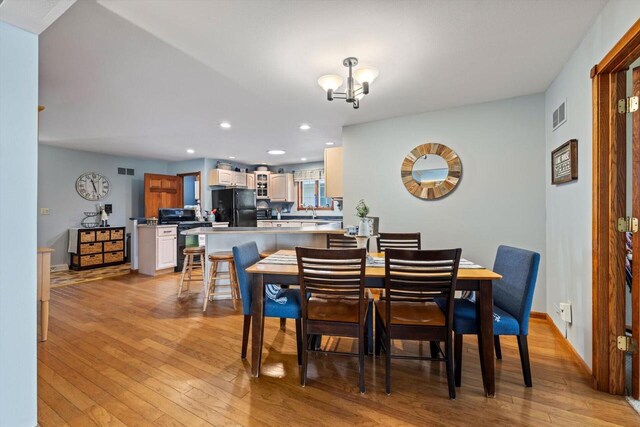 W1335 N Blue Spring Lake Dr, Palmyra, WI 53156 - dining area featuring visible vents, a chandelier, baseboards, recessed lighting, and light wood-style floors