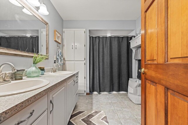 W1335 N Blue Spring Lake Dr, Palmyra, WI 53156 - full bath featuring tile patterned floors, a shower with shower curtain, double vanity, and a sink