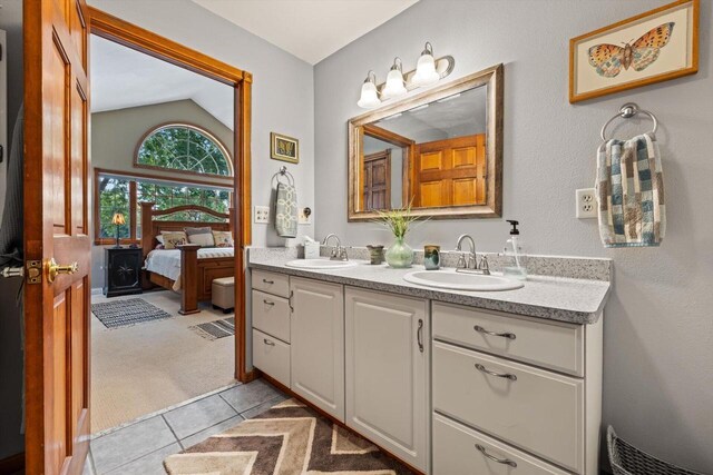 W1335 N Blue Spring Lake Dr, Palmyra, WI 53156 - bathroom featuring double vanity, a sink, vaulted ceiling, and ensuite bath