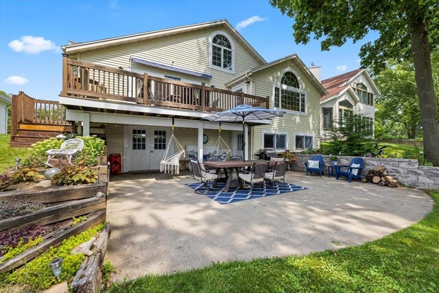 W1335 N Blue Spring Lake Dr, Palmyra, WI 53156 - back of property with outdoor dining area, a deck, and a patio