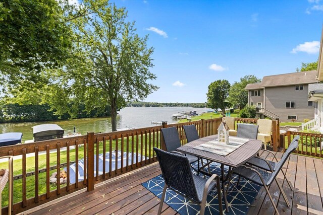 W1335 N Blue Spring Lake Dr, Palmyra, WI 53156 - wooden deck featuring area for grilling, outdoor dining space, and a water view