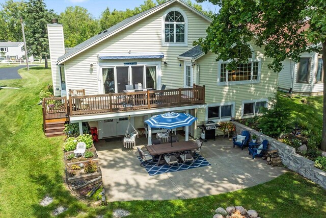 W1335 N Blue Spring Lake Dr, Palmyra, WI 53156 - back of property with a wooden deck, a chimney, outdoor dining area, a yard, and a patio area