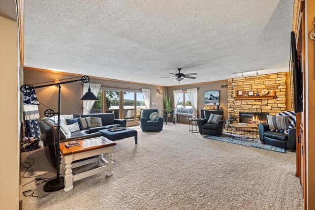 W1335 N Blue Spring Lake Dr, Palmyra, WI 53156 - living room featuring a fireplace, ceiling fan, carpet flooring, and a textured ceiling