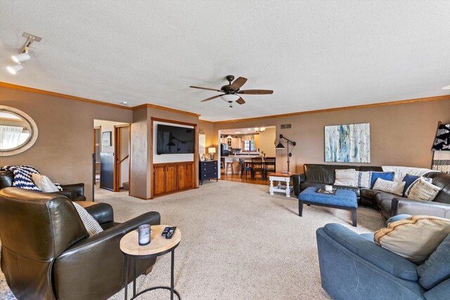 W1335 N Blue Spring Lake Dr, Palmyra, WI 53156 - living room featuring carpet flooring, a textured ceiling, crown molding, and ceiling fan