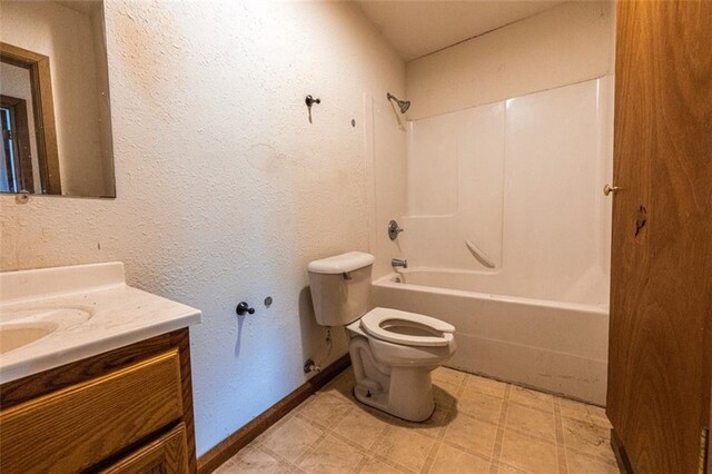bathroom with tile patterned floors, toilet, vanity, shower / bathtub combination, and baseboards