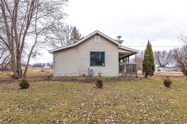 view of property exterior featuring covered porch and a yard