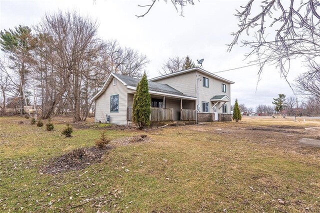 view of front of house with a front yard and a porch
