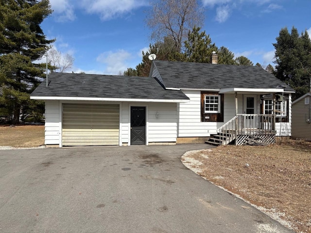 1006 Lulu Ave, Crivitz, WI 54114 - view of front of property with roof with shingles, a garage, aphalt driveway, and a chimney