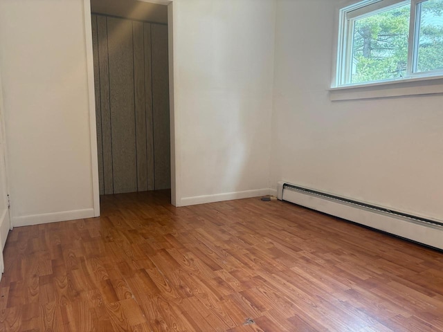 1006 Lulu Ave, Crivitz, WI 54114 - empty room featuring light wood finished floors, baseboards, and baseboard heating