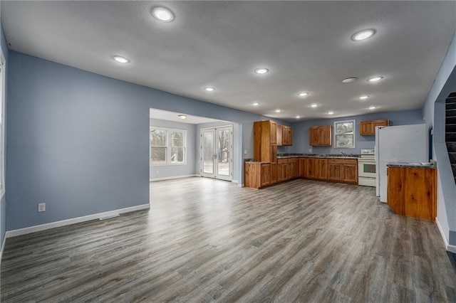 3202 120th St, Chippewa Falls, WI 54729 - kitchen with a wealth of natural light, dark wood finished floors, open floor plan, brown cabinetry, and white appliances