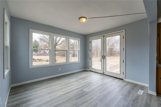 3202 120th St, Chippewa Falls, WI 54729 - spare room featuring french doors, visible vents, baseboards, and wood finished floors