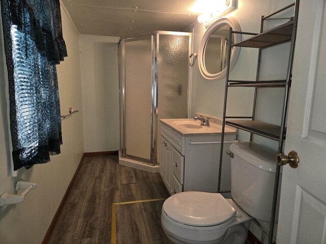 N10444 N Horseshoe Rd, Tomahawk, WI 54487 - bathroom featuring toilet, a stall shower, vanity, and wood finished floors