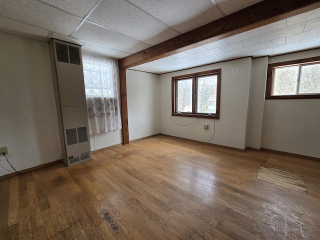 N10444 N Horseshoe Rd, Tomahawk, WI 54487 - unfurnished room with baseboards, a wealth of natural light, wood finished floors, and beam ceiling