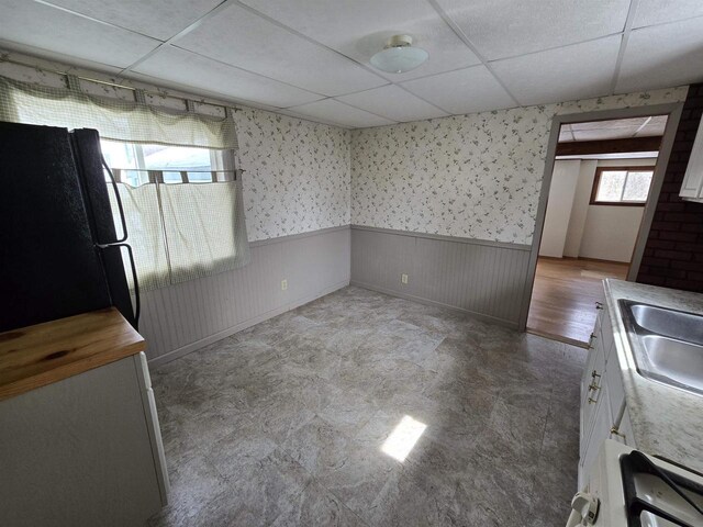 N10444 N Horseshoe Rd, Tomahawk, WI 54487 - kitchen with a wainscoted wall, a sink, freestanding refrigerator, wallpapered walls, and a paneled ceiling