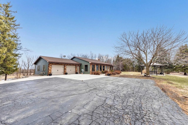 3237 Mill Rd, Greenleaf, WI 54126 - view of front of home with an attached garage, a gazebo, and decorative driveway