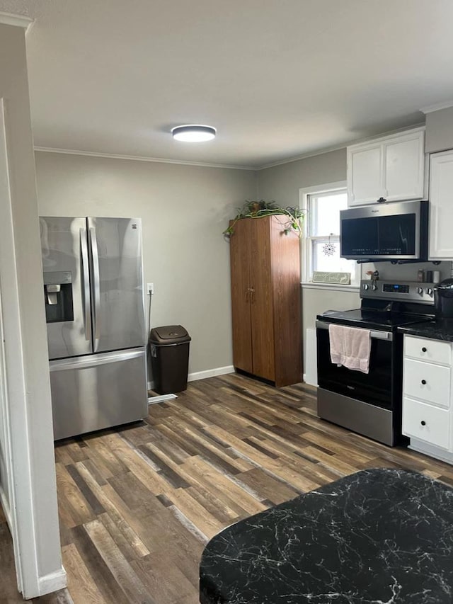 25290 Foothill Ave, Tomah, WI 54660 - kitchen with dark wood-style floors, dark countertops, white cabinets, and stainless steel appliances