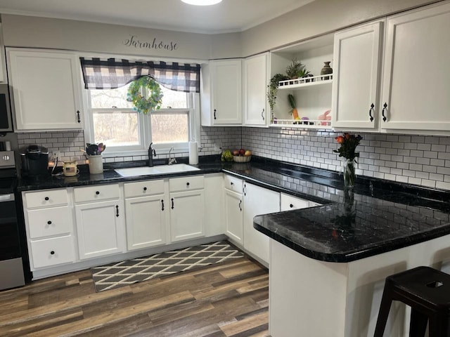 25290 Foothill Ave, Tomah, WI 54660 - kitchen with white cabinets, dark wood finished floors, a sink, open shelves, and backsplash