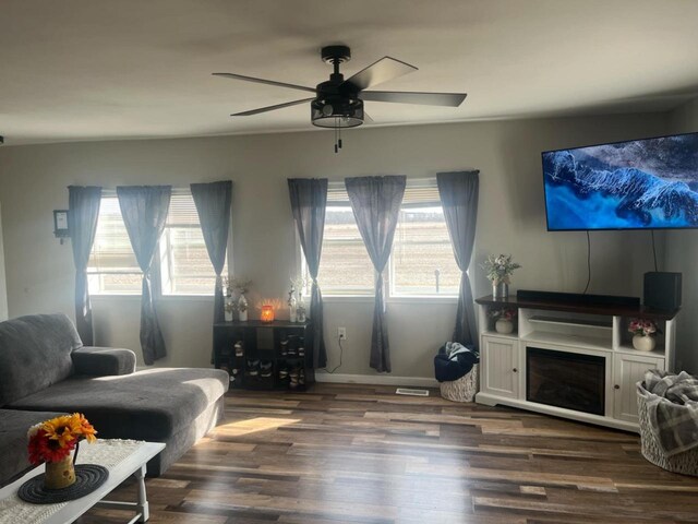 25290 Foothill Ave, Tomah, WI 54660 - living room with a fireplace, ceiling fan, visible vents, and dark wood finished floors