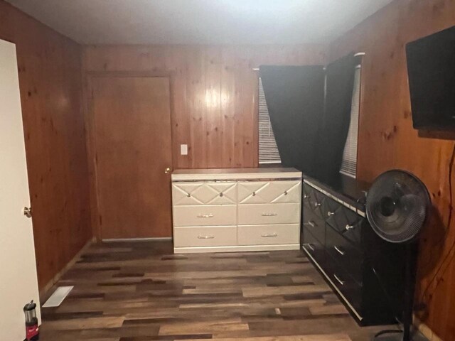 25290 Foothill Ave, Tomah, WI 54660 - bedroom featuring dark wood-style floors and wood walls