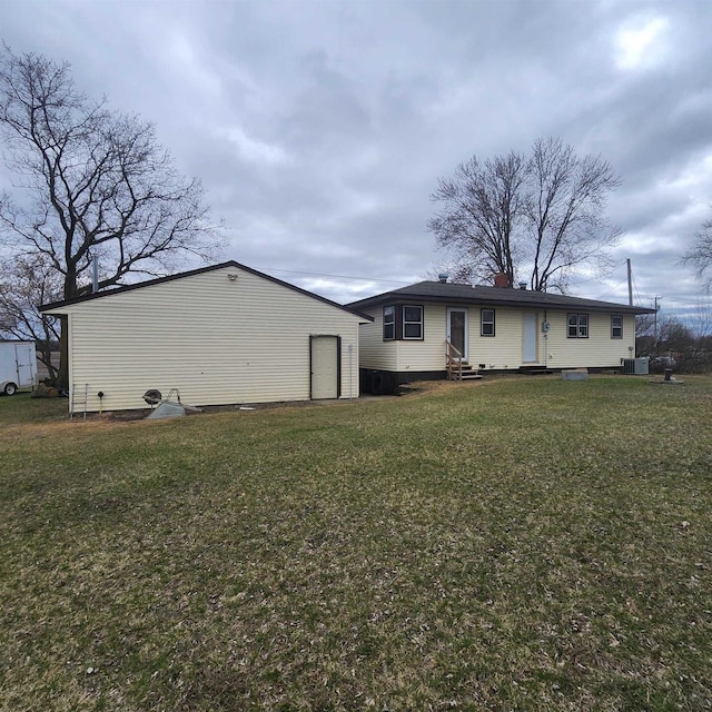 25290 Foothill Ave, Tomah, WI 54660 - back of property featuring cooling unit, entry steps, an outbuilding, and a yard