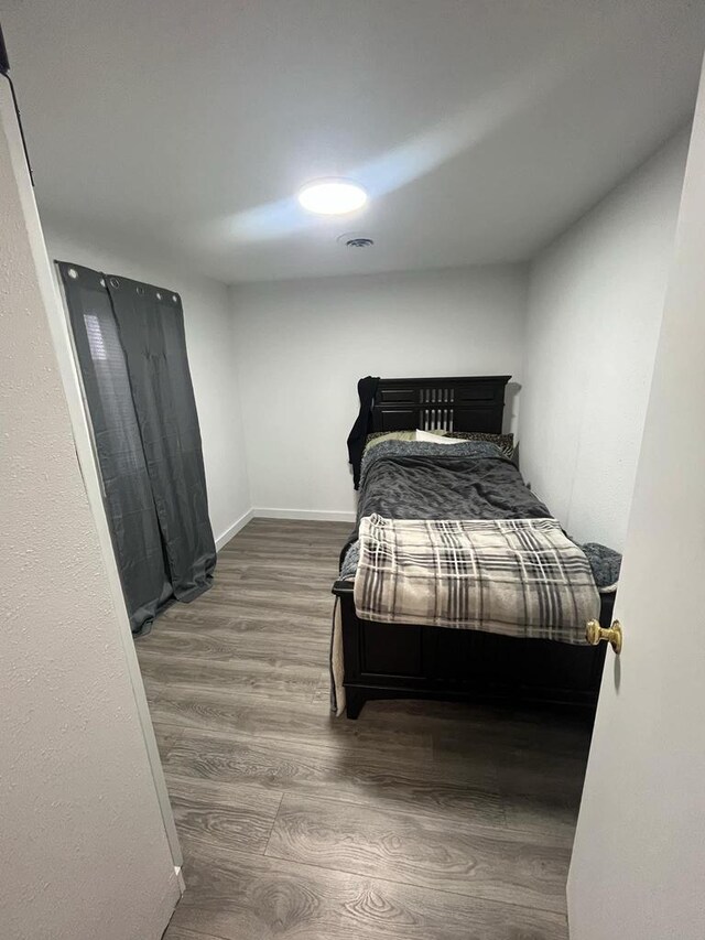 25290 Foothill Ave, Tomah, WI 54660 - bedroom featuring visible vents, baseboards, and wood finished floors