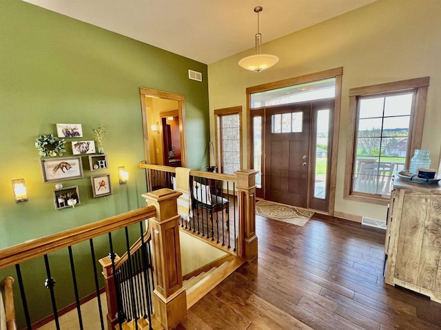 foyer with baseboards, dark wood-style flooring, and visible vents