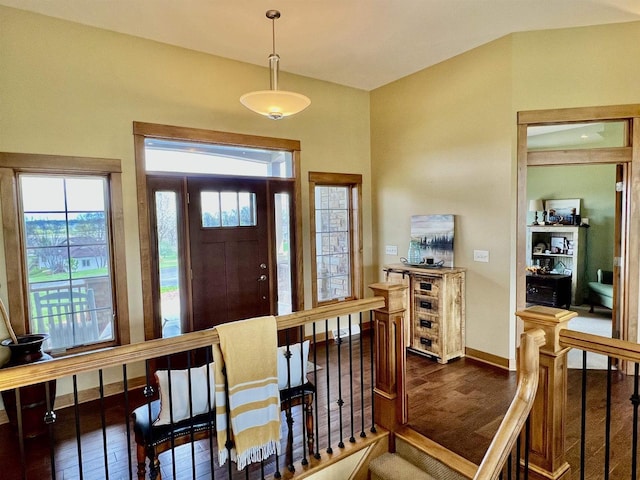 foyer featuring baseboards and dark wood-style flooring