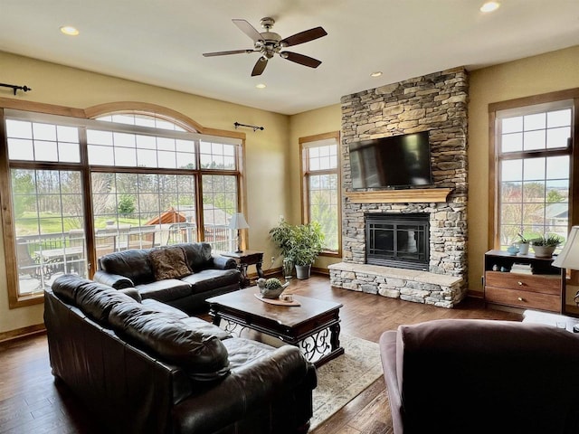 living room with baseboards, recessed lighting, ceiling fan, hardwood / wood-style floors, and a fireplace