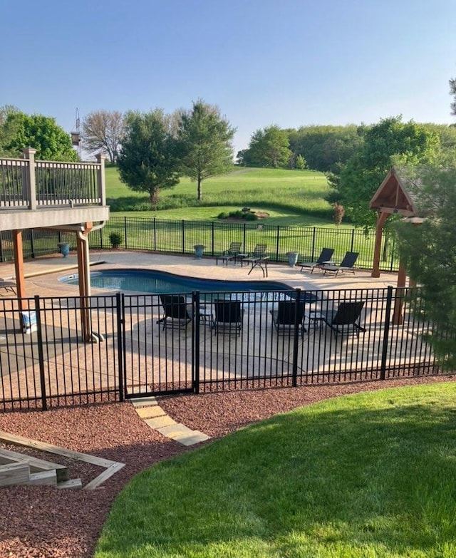 view of swimming pool featuring fence, a patio, and a fenced in pool
