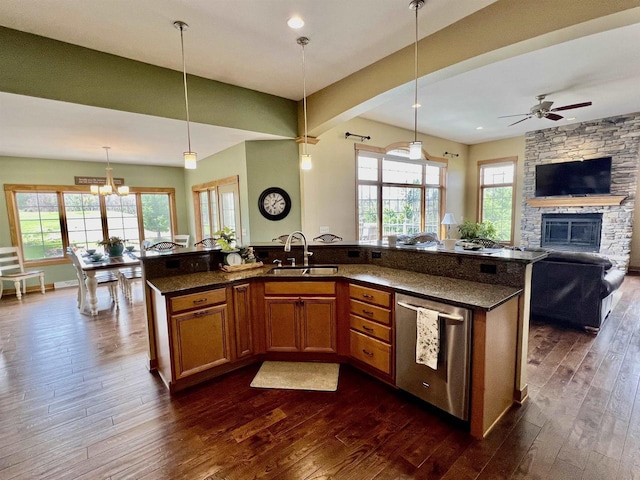 kitchen featuring open floor plan, dishwasher, a wealth of natural light, and dark wood-style flooring