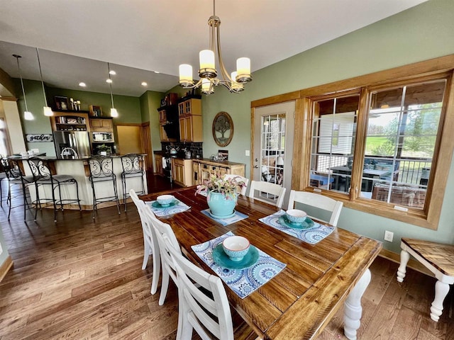 dining space with recessed lighting, baseboards, dark wood-style floors, and an inviting chandelier