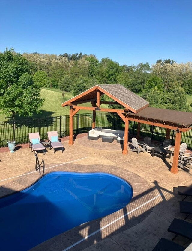 view of swimming pool featuring fence, a fenced in pool, a gazebo, and a patio