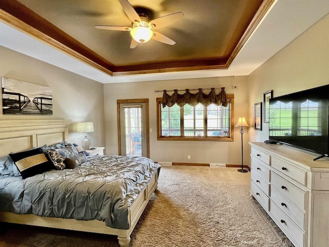 carpeted bedroom with baseboards, visible vents, access to outside, and a raised ceiling