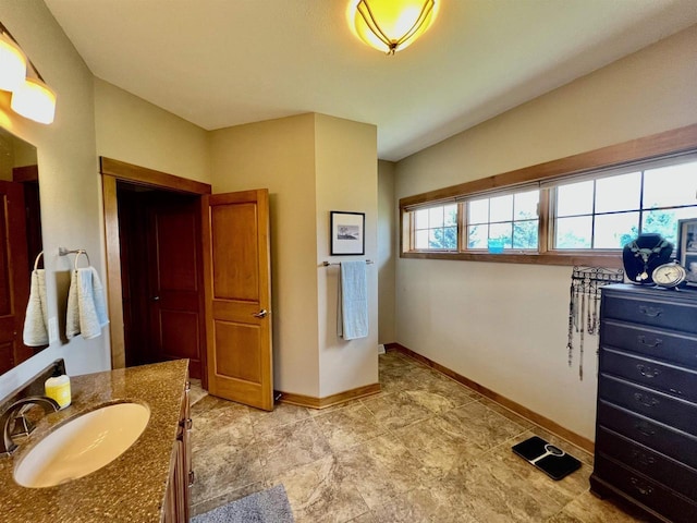 bathroom with baseboards and vanity