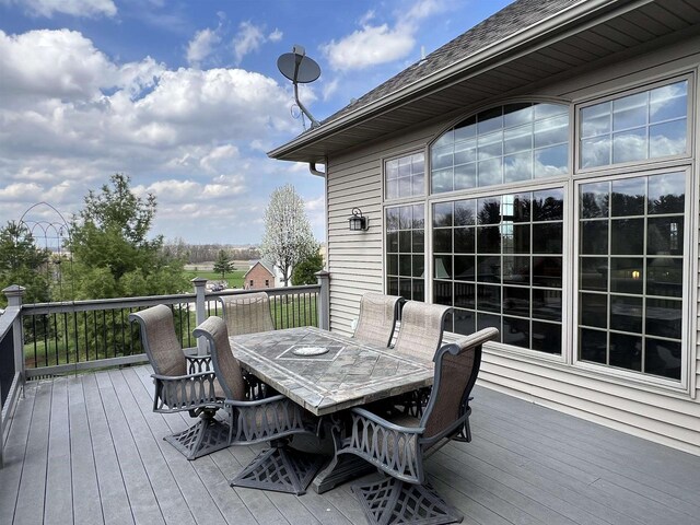 wooden terrace with outdoor dining area