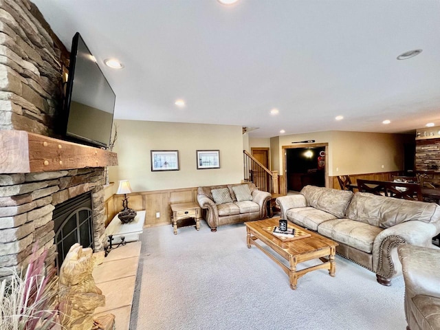 living room featuring wainscoting, carpet, a fireplace, and recessed lighting