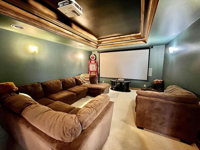 home theater room featuring carpet floors, a tray ceiling, and visible vents