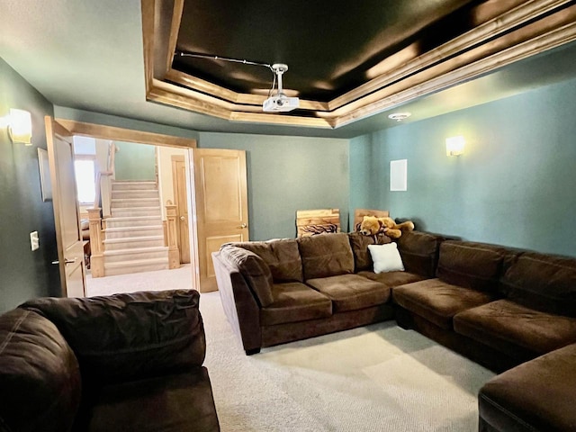 carpeted home theater room with a raised ceiling