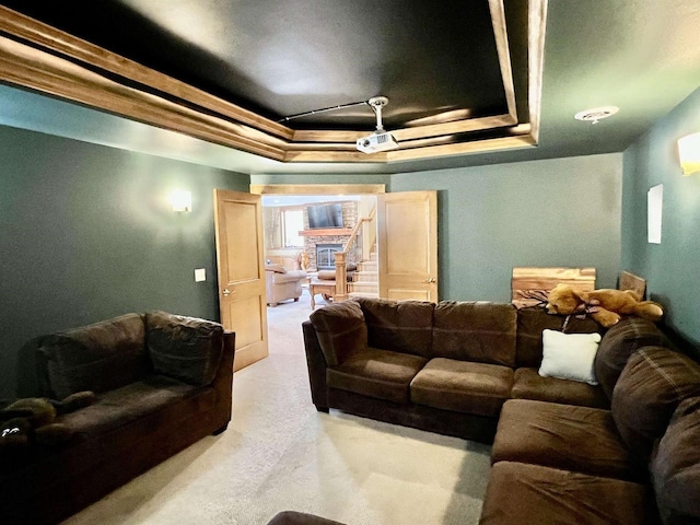 living area with light colored carpet and a tray ceiling