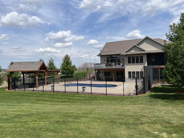 view of swimming pool featuring a gazebo, a yard, a fenced in pool, and fence