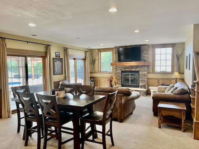 dining area featuring light carpet, a fireplace, and recessed lighting