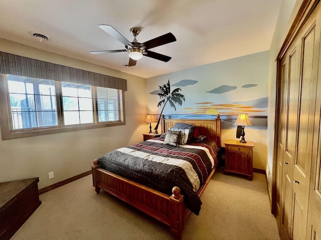 bedroom with a closet, ceiling fan, light colored carpet, baseboards, and visible vents